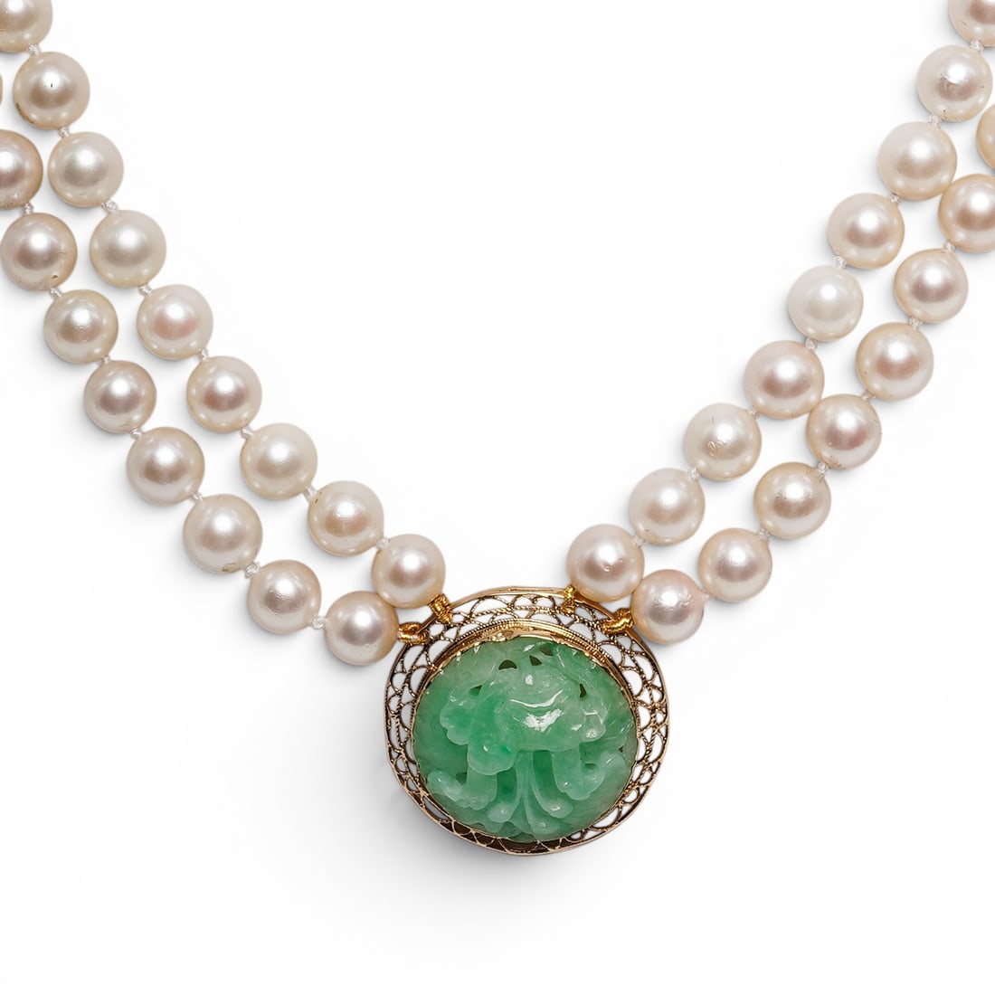 Gilt Sterling Pearls & Carved Jade Necklace: Gilt Sterling Pearls & Carved Jade Necklace 21st. Cent. A double-strand cultured pearl necklace featuring hand-knotted pearls secured by a large, ornamental centerpiece. The centerpiece consists of a 