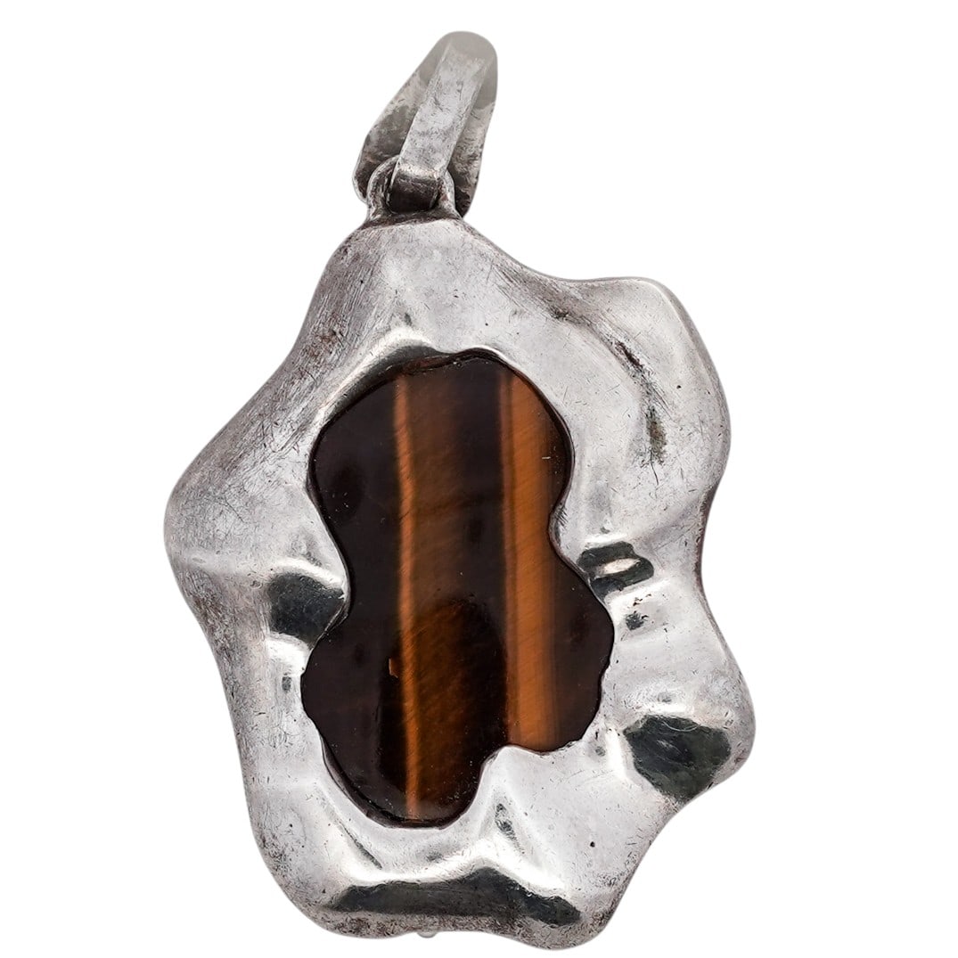 Vintage Sterling Silver Tiger’s Eye Organic Form Pendant Signed: Vintage Sterling Silver Tiger’s Eye Organic Form Pendant Signed 1970s–1980s Freeform sterling silver pendant centered with a polished tiger’s eye cabochon displaying strong chatoyancy, set