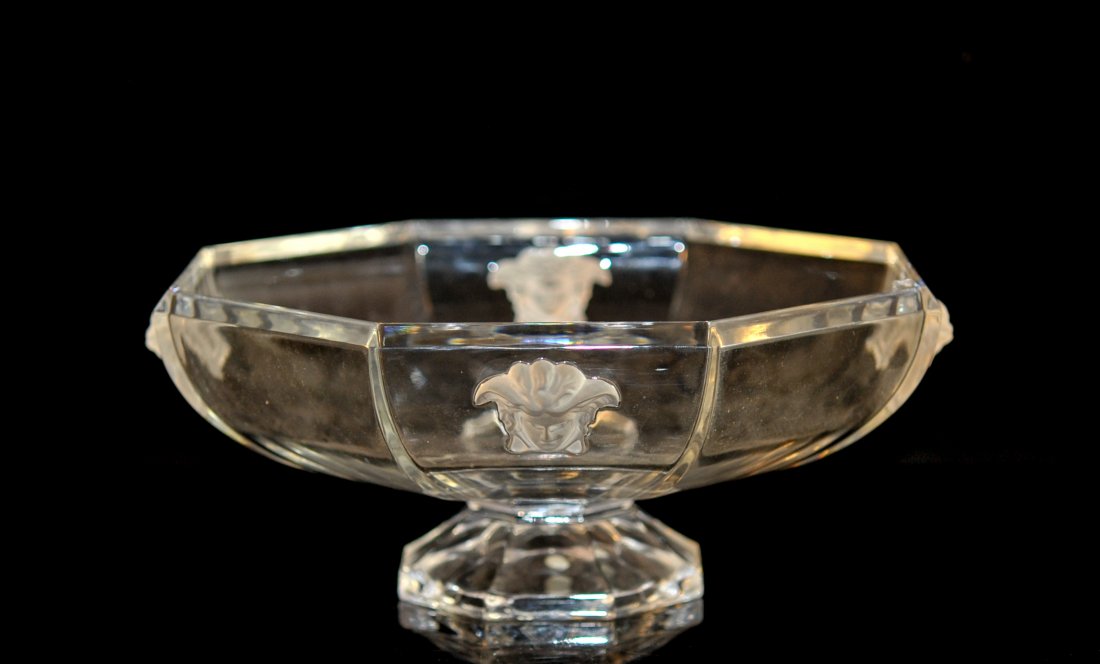 Versace crystal "Medusa" footed desert bowl: DESCRIPTION: Versace crystal "Medusa" Lumiere footed desert bowl. Clear crystal design features four frosted applied Medusa heads on the exterior of the piece. Octagonal pedestal design. Piece is in m