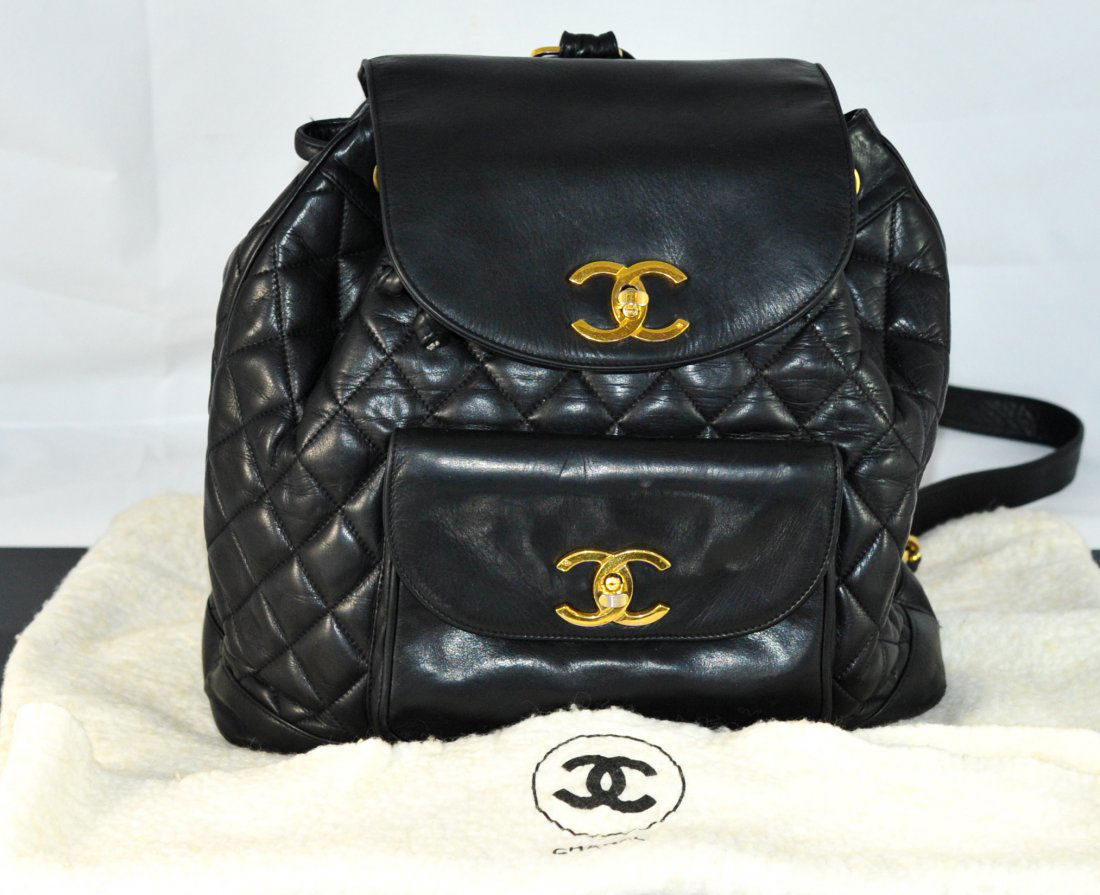 Authentic Chanel lamb skin quilted backpack: DESCRIPTION: Authentic Chanel lamb skin quilted backpack. Gorgeous Coco Chanel quilted backpack. made form rich black lamb skin featuring a main pouch with two internal zipper pockets and one small la