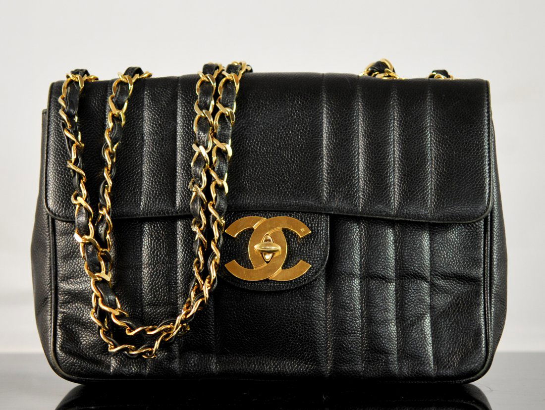 Authentic Coco Chanel leather evening bag: DESCRIPTION: Authentic Coco Chanel leather evening bag. Elegant Chanel bag featuring a slim body design with a gold plated hardware latch flap. Double leather and metal shoulder straps. Interior has a
