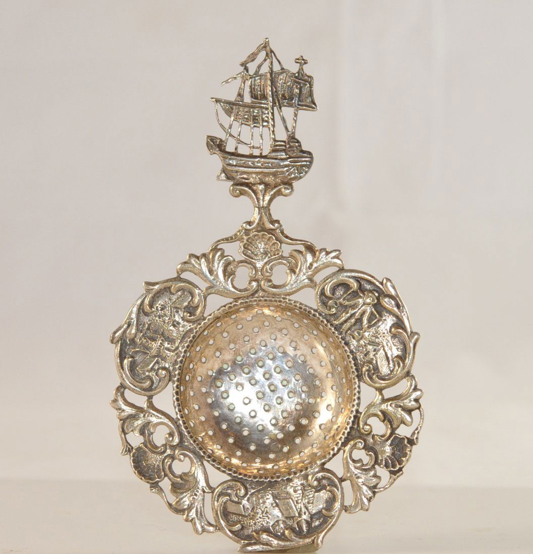 Antique Dutch silver mote spoon. Hallmarked: DESCRIPTION: Antique Dutch silver mote spoon. Colander center bordered by intricate raised design of small dutch villages with laborers. Adorned by foliate and shell designs throughout piece. The fini