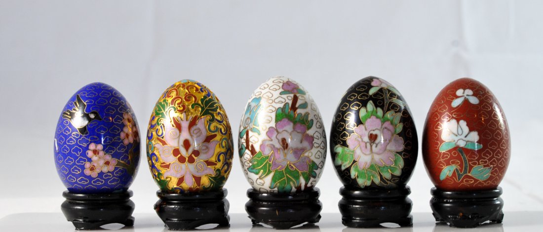 Set of five Chinese cloisonne and champleve eggs: DESCRIPTION: Set of five Chinese cloisonne and champleve eggs. Four multi colored cloisonne eggs (Black, white, blood red, and royal blue) with butterfly, bird, and floral designs all in superb condit