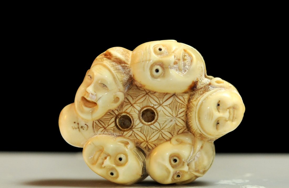 Antique Chinese hand carved ivory "12 face" netsuke: DESCRIPTION: Antique Chinese hand carved ivory "12 face" netsuke. Featuring twelves hand carved faces done from one piece of ivory all ranges of emotions. Double sided design. Aged patina. Superb carv
