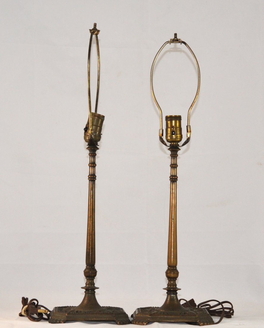 Pair of "Oscar Bach" (1884-1957) bronze lamps: DESCRIPTION: Pair of "Oscar Bach" (1884-1957) bronze lamps. Each lamp features extremely ornate floral inspired bases with four claw feet. The graduating shaft sits a top a hand hammered base. Simple