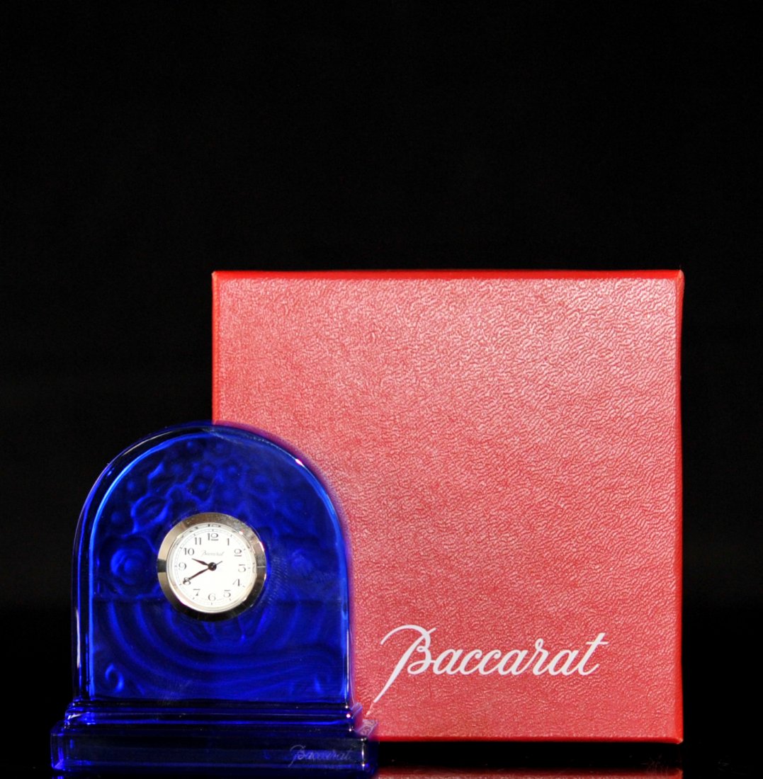 Bacarrat cobalt blue crystal desk clock. Original box: DESCRIPTION: Bacarrat cobalt blue crystal desk clock. Solid cobalt clear crystal body. The reverse has an engraved floral design with a matte finish. Step base design. The center has a fitted quartz "