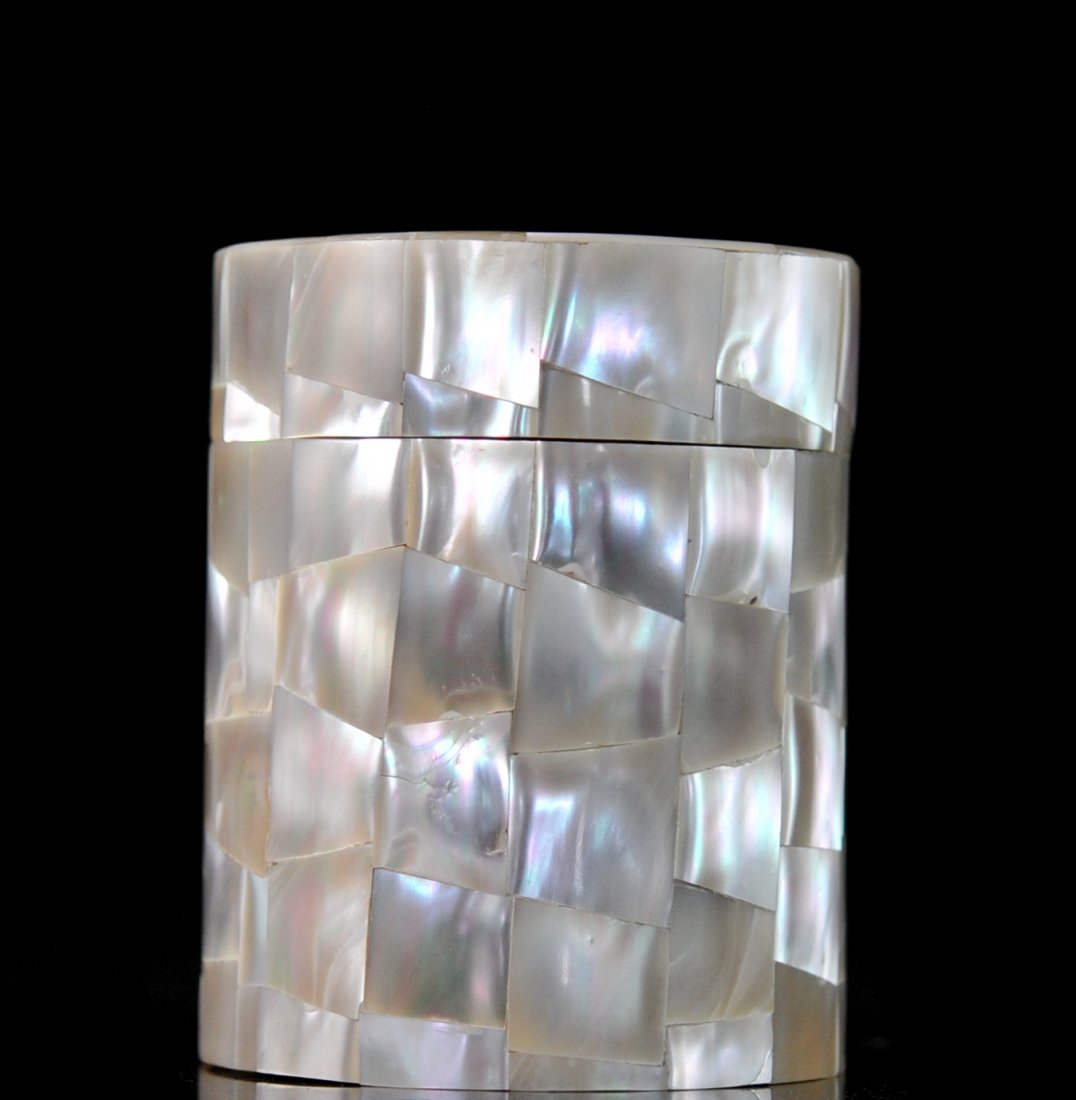 Mother of pearl tile cylindrical trinket box: DESCRIPTION: Mother of pearl tile cylindrical trinket box. Made from solid wood, the whole body and lid of the piece is covered with dove tail design mother of pearl tiles. The interior is lined in pi