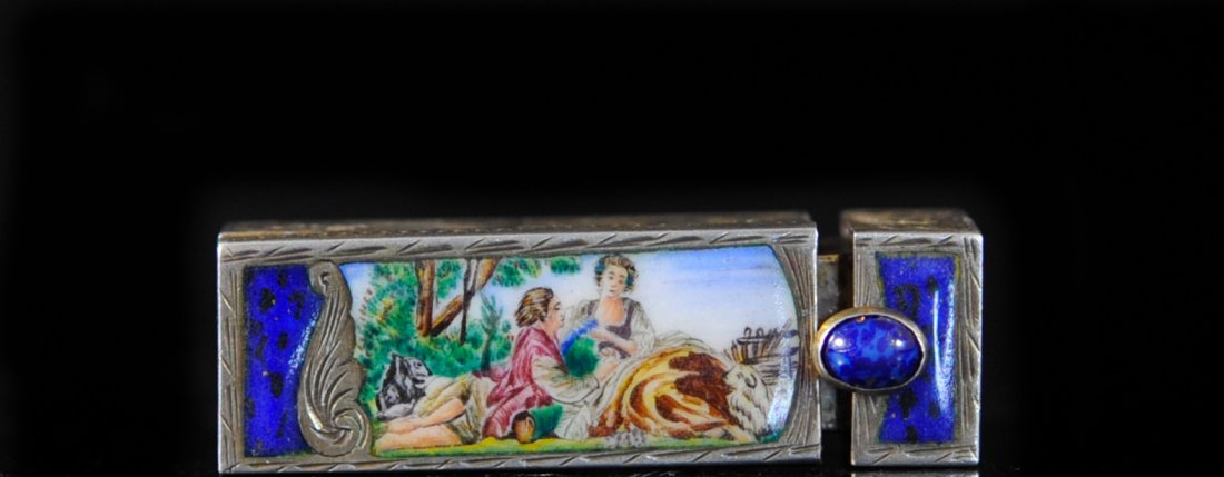 19th century French silver and enamel lipstick case: DESCRIPTION: 19th century French silver and enamel lipstick case. Solid 800 silver case engraved in foliate crests. Hand painted enamel scene of a woman and man resting in the shade of a tree flanked 
