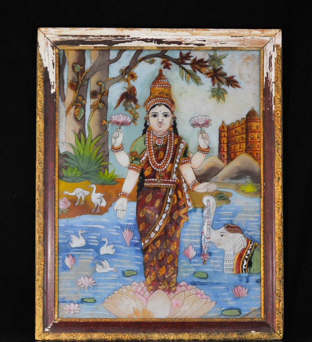 Antique Indian reverse framed painting of "Shiva": DESCRIPTION: Antique Indian reverse framed painting of "Shiva". Depiction of Shiva standing on a floating bed of lotus leaves holding two lotus flowers. She is adorned by geese, exotic birds and a sma