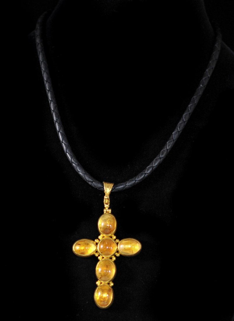 24k yellow gold and citrine cross by "Gurhan": DESCRIPTION: 24k yellow gold and citrine cross by "Gurhan". Solid 24k body divided into six sections featuring cabochon cut citrine stones bezeled in 24k Case. Hand hammered backing. The citrine stone