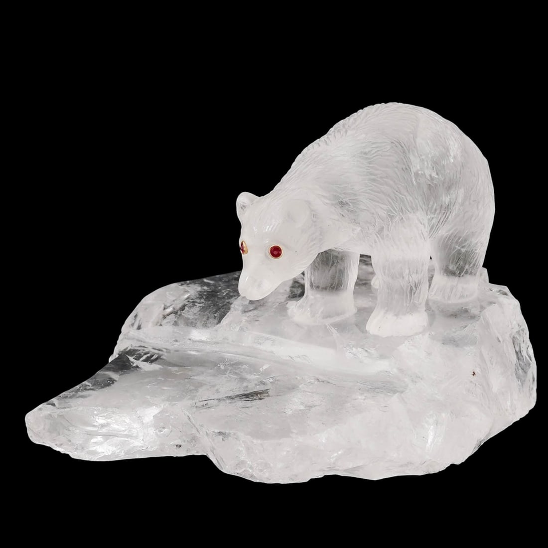 Russian Carved Rock Crystal Polar Bear Figurine: Russian Carved Rock Crystal Polar Bear Figurine20th century, RussiaA carved rock crystal Russian polar bear figurine with gold and ruby inset eyes.H 2.5" x L 4" x W 3.25"