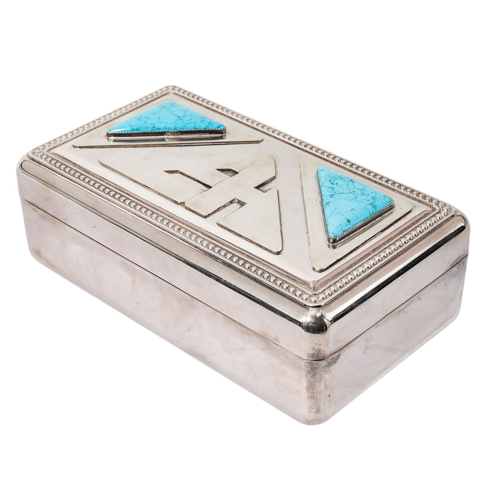 Southwestern Silver Plated & Turquoise Jewelry Box: Southwestern Silver Plated & Turquoise Jewelry BoxLate 20th century, AmericanSilver Plated jewelry box featuring two triangular turquoise cabochons and raised "EH" monogram in the center. The hinged l