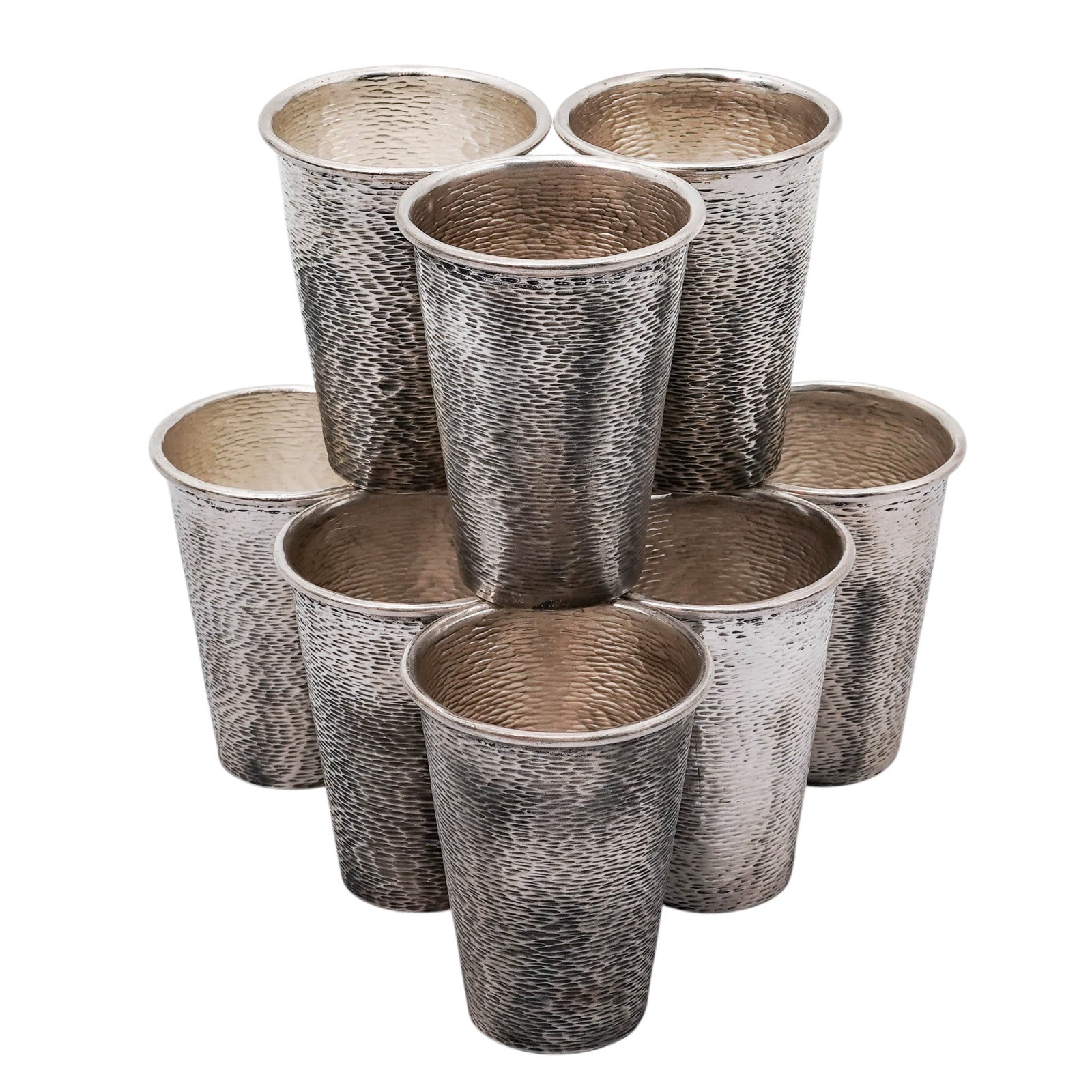 (9 pcs) Antonio Pineda Mexican Sterling Shot Glasses: (9 pcs) Antonio Pineda Mexican Sterling Shot Glassescirca 1940s, MexicanGrouping of hammered Mexican sterling silver liquor cups. They are stamped with the AP hallmark, Taxco, and 980 on the underside