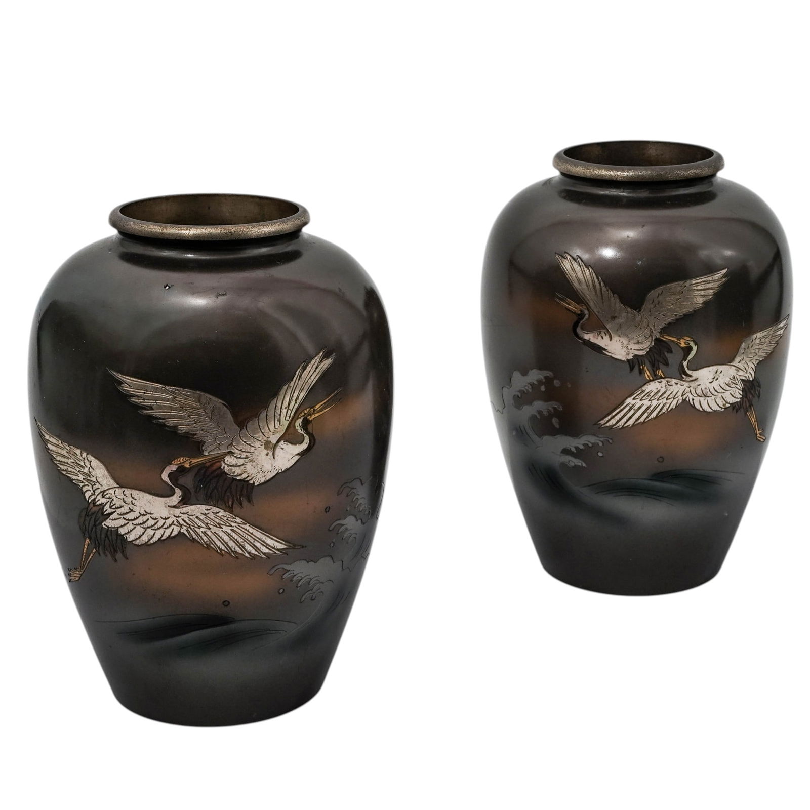 Pair Of Japanese Inlay Bronze Crane Vases: Pair Of Japanese Inlay Bronze Crane VasesEarly 20th century, JapaneseJapanese bronze vases with gold and silver inlay, featuring a bulbous form with a narrow neck. Each vase features a high-relief and