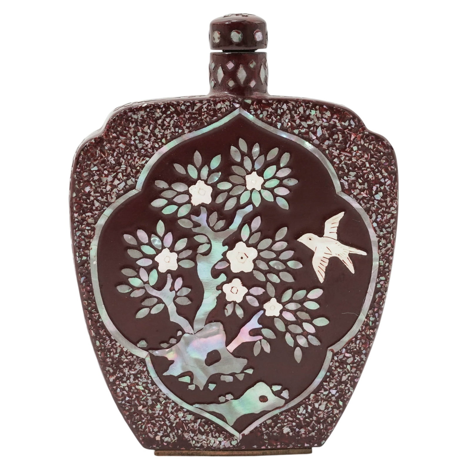 Chinese Mother Of Pearl and Lacquer Snuff Bottle: Chinese Mother Of Pearl and Lacquer Snuff Bottle20th century, ChineseThe snuff bottle's central panel depicts a blossoming plum tree and a bird in flight. The iridescent quality of the design comes fr