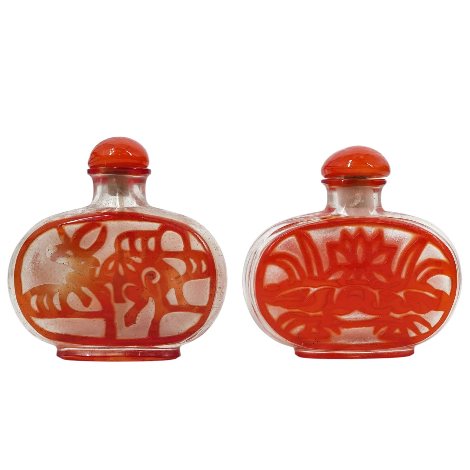(2 pcs) Chinese Peking Glass Snuff Bottles: (2 pcs) Chinese Peking Glass Snuff BottlesEarly 20th century, ChineseAntique Chinese Peking glass snuff bottles featuring ruby red overlay and orange tops. They have their original stoppers and spoons
