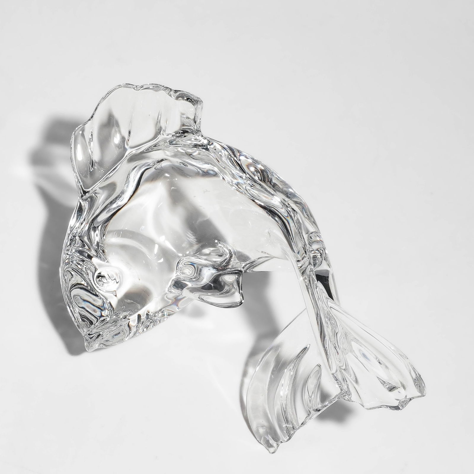 Baccarat Crystal Fish Figurine: Baccarat Crystal Fish Figurine20th century, FrenchThis is a vintage Baccarat crystal fish figurine, a solid lead crystal sculpture from France that depicts a stylized goldfish or koi in a graceful, le