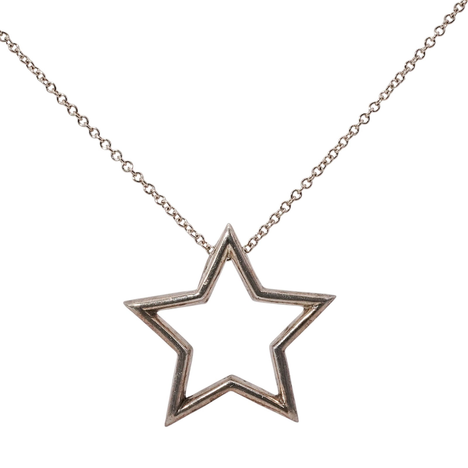 Tiffany & Co. Sterling Silver Star Pendant Necklace: Tiffany & Co. Sterling Silver Star Pendant Necklace21st Century, USATiffany & Co. sterling silver necklace featuring an open-work five-point star pendant on a fine link chain. The pendant reverse is h