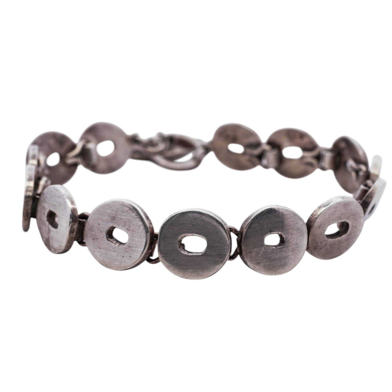 Mexican Sterling Silver Toggle Bracelet: Mexican Sterling Silver Toggle Bracelet1980s–1990s, MexicoMexican sterling silver toggle bracelet composed of circular disc links with elongated central apertures, joined by short articulated connec