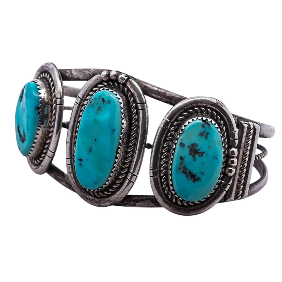 Vintage Navajo Sterling Silver & Turquoise Cuff, Signed: Vintage Navajo Sterling Silver & Turquoise Cuff, Signed1960s-1970s, USA.Vintage Navajo sterling silver cuff bracelet set with three turquoise cabochons, each framed in twisted rope silver and mounted