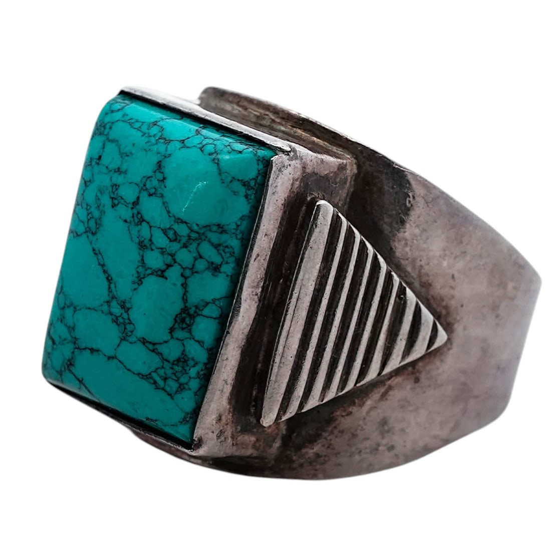 Vintage Sterling Silver Turquoise Ring: Vintage Sterling Silver Turquoise RingLate 20th CenturySterling silver ring set with a rectangular cabochon turquoise measuring approximately 14 × 11 mm and displaying dark matrix throughout. The sto