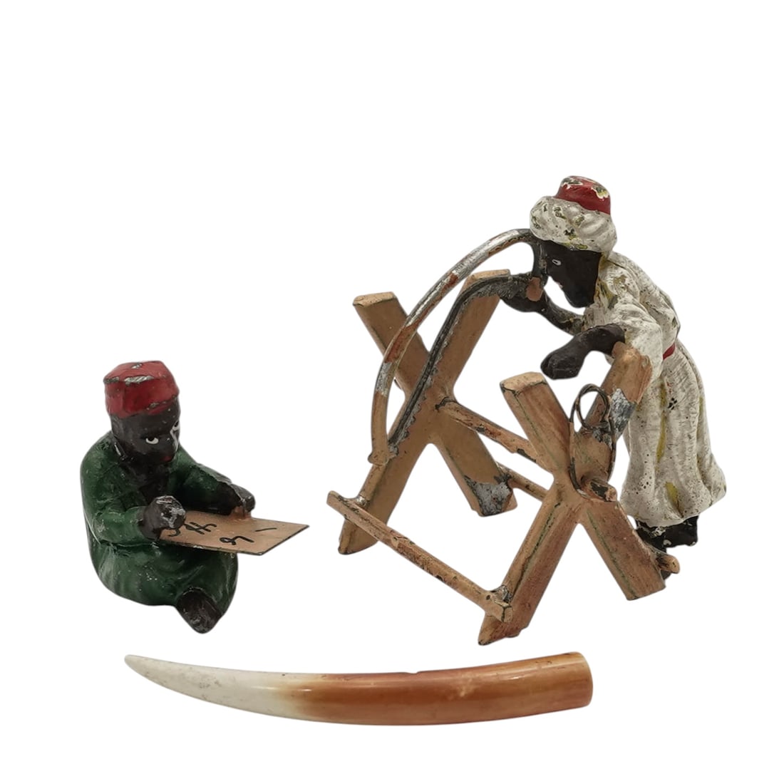 (2 pcs) Vienna Bronze Blackamoor Figurines: (2 pcs) Vienna Bronze Blackamoor FigurinesLate 19th- early 20th century, AustrianAntique cold-painted cast bronze figurines featuring African individuals in traditional attire. One is engaged in "bone