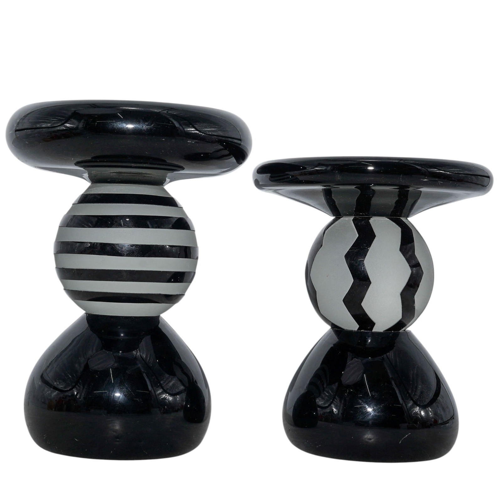 (2 pcs) Signed Studio Art Glass Candle Holders: (2 pcs) Signed Studio Art Glass Candle Holders20th centuryCrafted with a glossy, polished finish, each holder is composed of a wide black top supported by a spherical stem decorated with alternating o