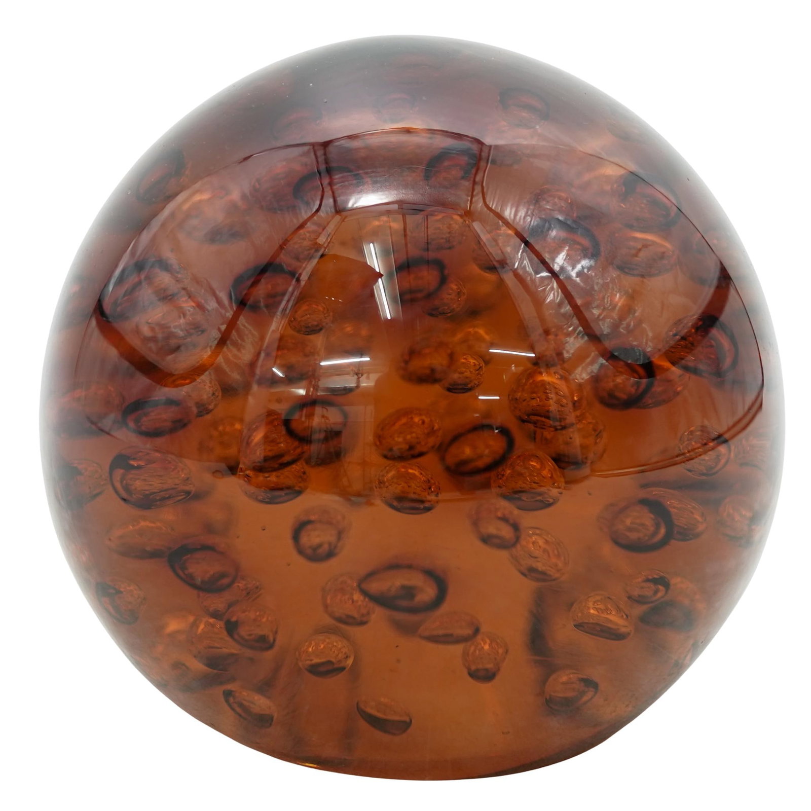 Art Glass Controlled Bubble Sphere: Art Glass Controlled Bubble SphereMid 20th centuryThis vintage amber glass sphere is a hand-blown art glass piece featuring a rich honey-gold hue. It is crafted using the bullicante (controlled bubble