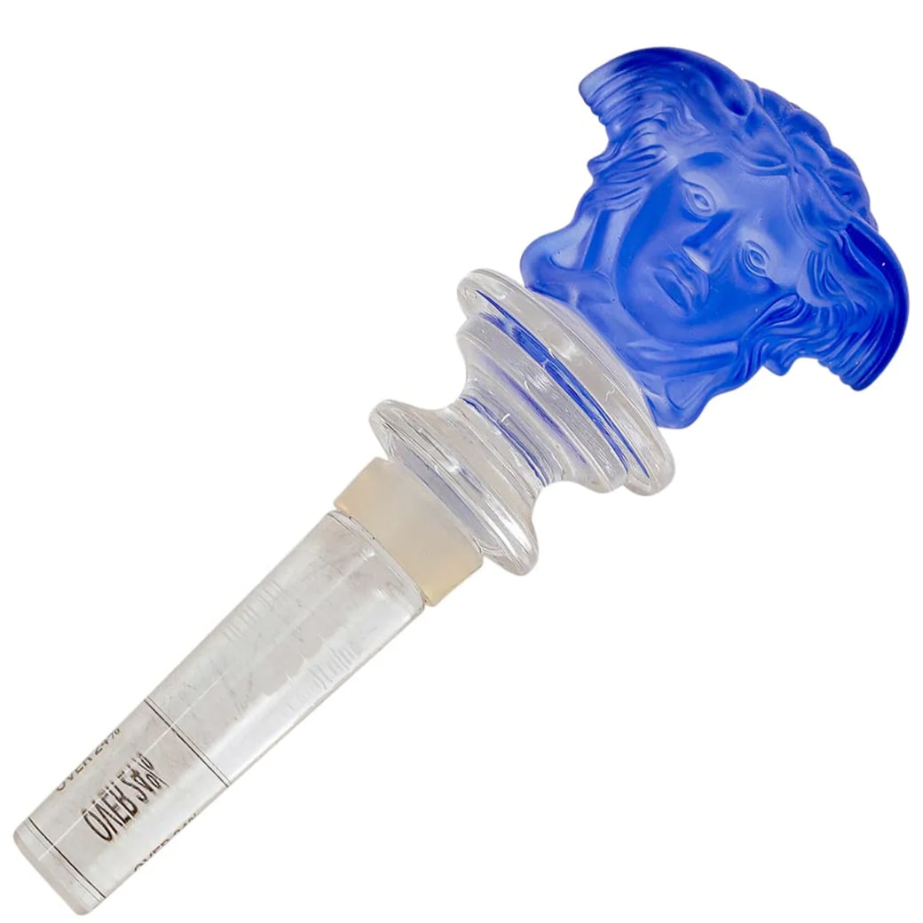 Versace x Rosenthal Medusa Blue Frosted Crystal Wine Bottle Stopper: Versace x Rosenthal Medusa Blue Frosted Crystal Wine Bottle Stopper20th century, GermanyVersace by Rosenthal "Medusa" head blue crystal frosted wine bottle stopper, Marked "Versace Rosenthal".H. 5.25"