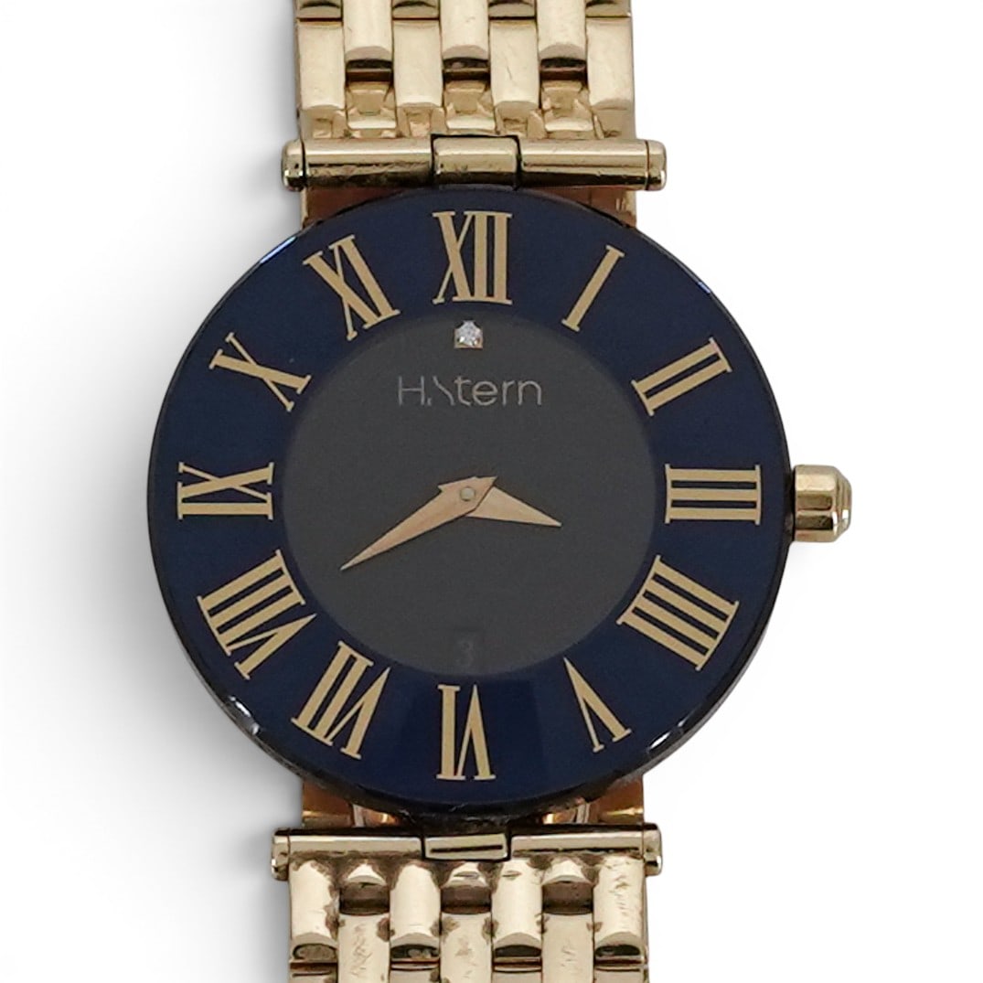 H. Stern 18k Gold "Sapphire" Watch REF 528 VII: H. Stern 18k Gold "Sapphire" Watch REF 528 VII 1990s, Swiss\ Brazilian H. Stern "Sapphire" 18k yellow gold quartz wristwatch with round case, blue chapter ring dial, gold Roman numerals, center black 