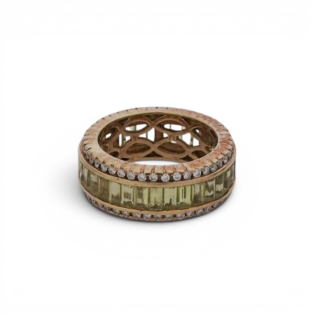 Sonia B. 18K Gold & Peridot Eternity Ring: Sonia B. 18K Gold & Peridot Eternity Ring 21st Cent., USA Sonia Bitton 18k yellow gold band ring set with a continuous row of channel set baguette cut peridot stones. Bordered on both edges rows of ro