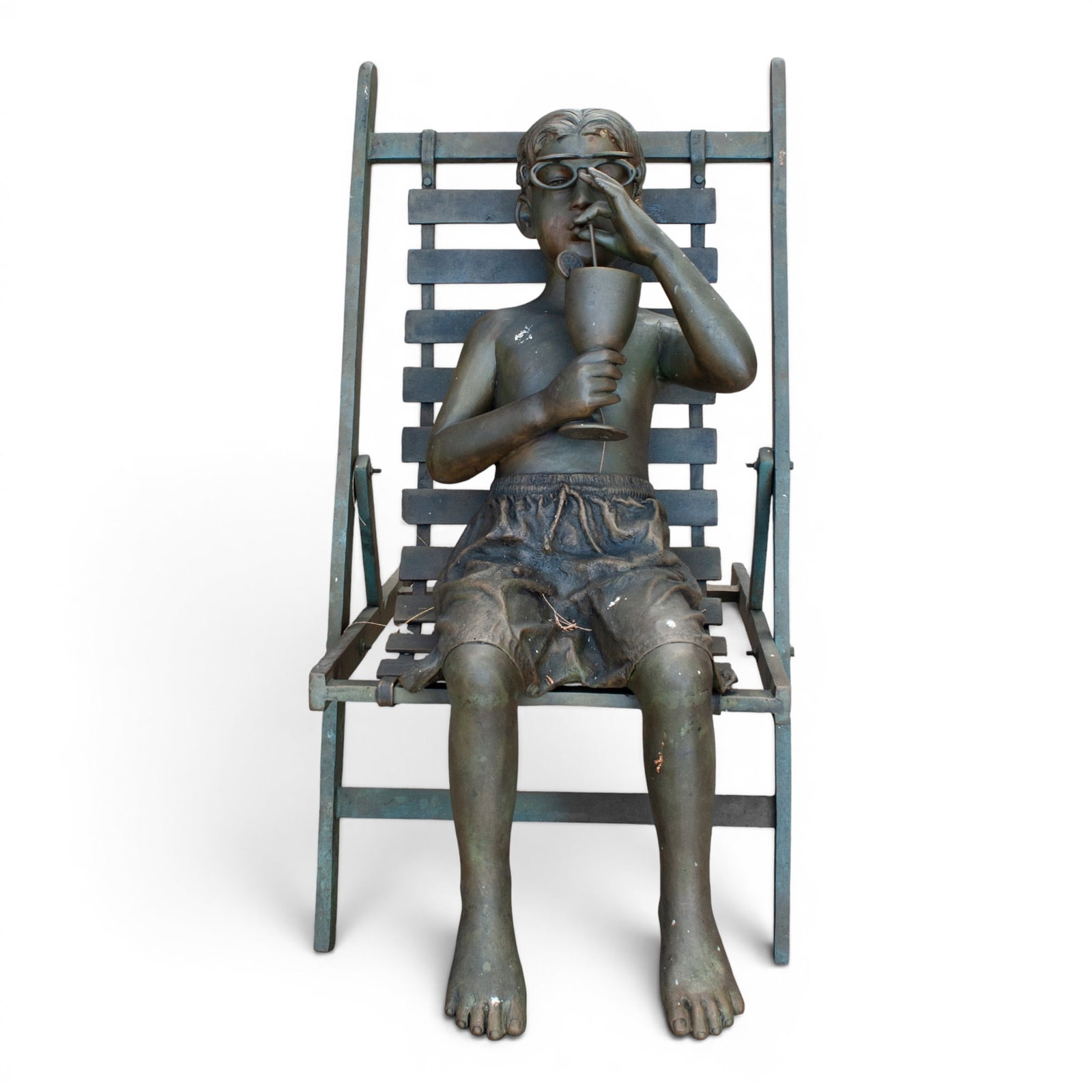 Large Garden Bronze Sculpture of a Boy Sipping Lemonade: Large Garden Bronze Sculpture of a Boy Sipping Lemonade 20th Century, USA Whimsical bronze sculpture depicting a young boy reclining in a lounge chair while sipping from a goblet and wearing sunglasse