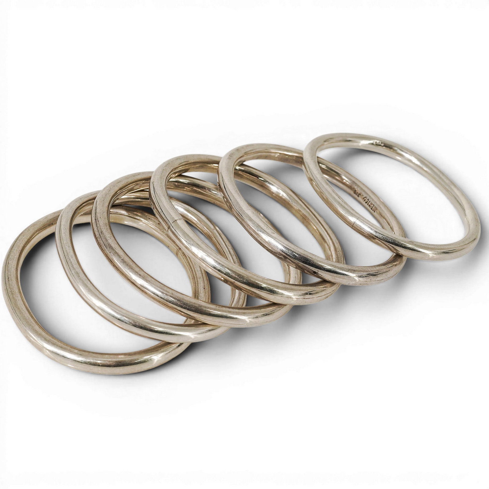 (6 Pc) Mexican Sterling Silver Bangle Bracelets: (6 Pc) Mexican Sterling Silver Bangle Bracelets 1Late 20th c., Mexico Sterling silver bangle bracelet set. (4) Are stamped "Mexico 925" and (2) are just stamped "925". Total weight: 153.8g Diameter: