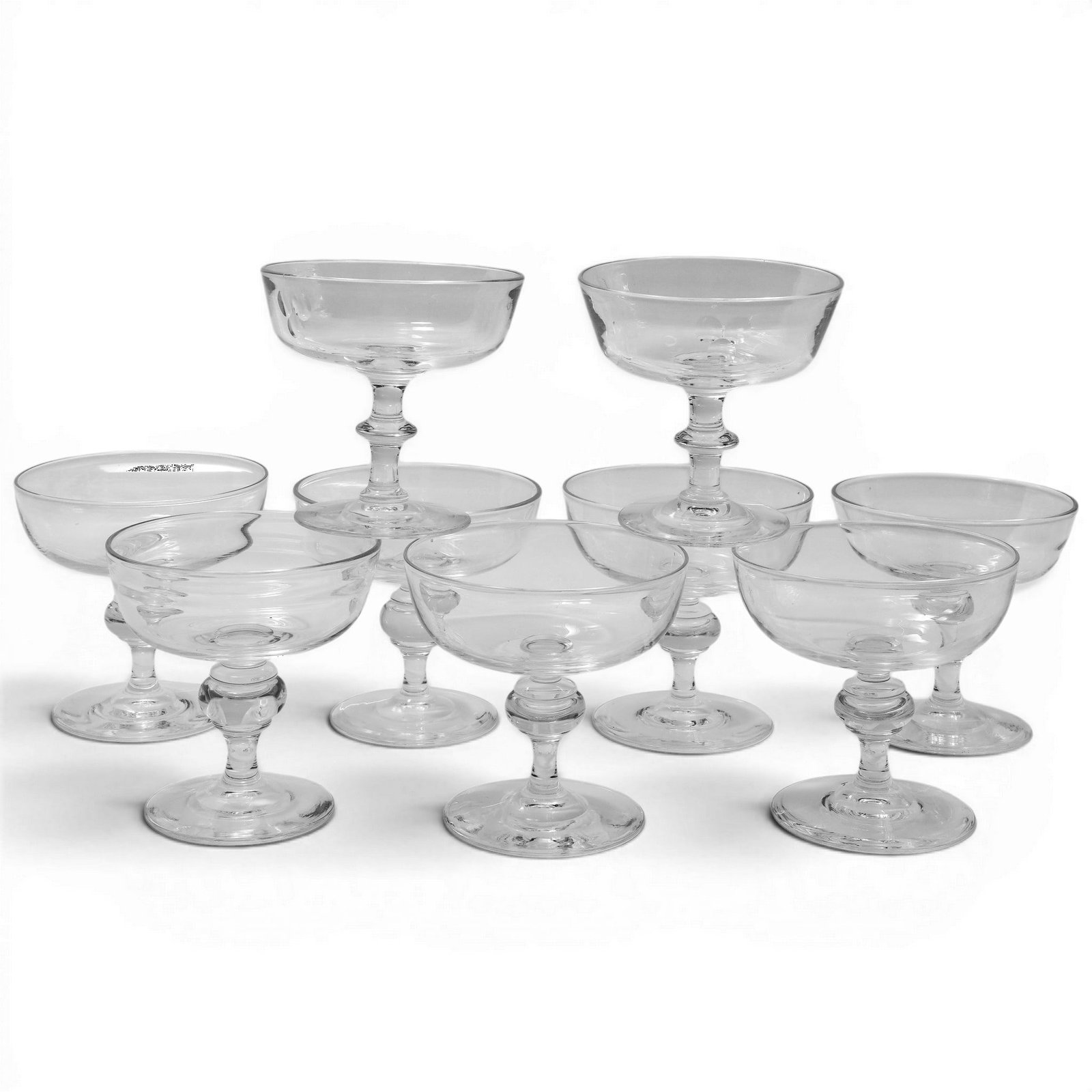 (9 pc) Steuben Glass Champagne Coupes / Sherbet Glasses: (9 pc) Steuben Glass Champagne Coupes / Sherbet Glasses c. 1940-1950s, USA These iconic mid century shapes designed by legendary artists Frederick Calder and George Thomson, feature classic design