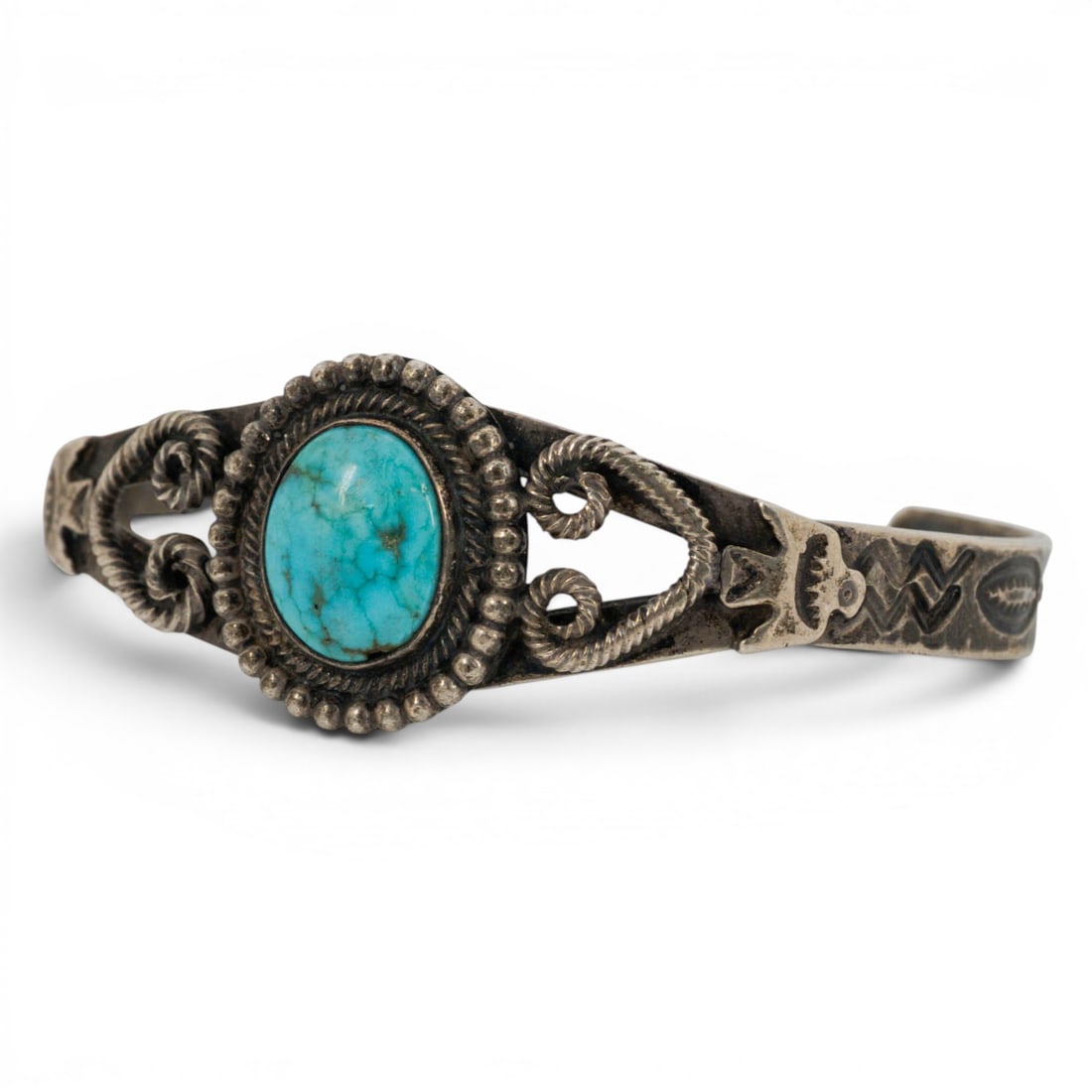Vintage Wolf-Road Navajo Sterling Silver & Turquoise Scrollwork Cuff Bracelet: Vintage Wolf-Road Navajo Sterling Silver & Turquoise Scrollwork Cuff Bracelet Late 20th Century, USA Vintage Navajo sterling silver cuff bracelet by Wolf-road, set with an oval turquoise cabochon with
