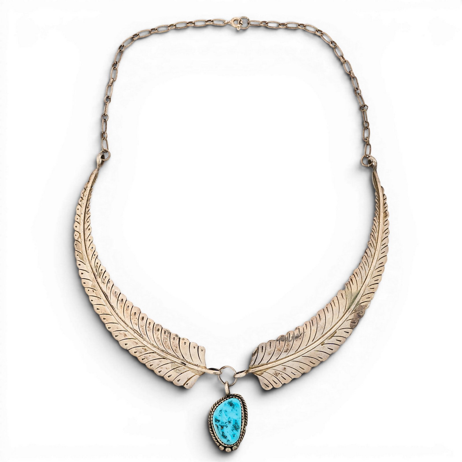 Vintage Navajo Sterling Silver & Turquoise Feather Necklace Signed: Vintage Navajo Sterling Silver & Turquoise Feather Necklace Signed 1970s-1980s, USA Vintage Navajo sterling silver necklace featuring two large stamped feather-form side panels joined below an oval tu