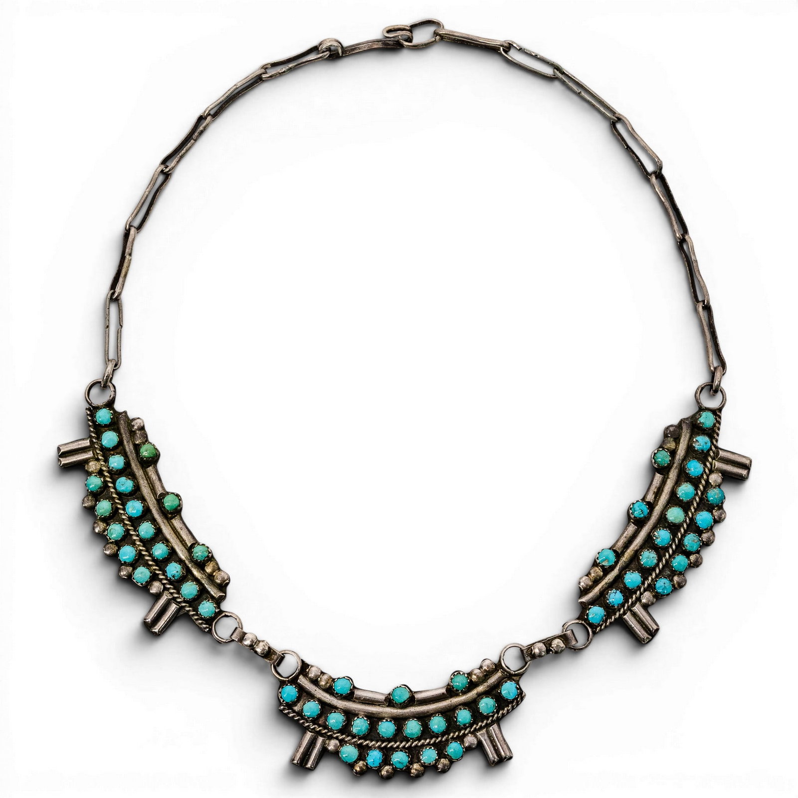 Vintage Navajo Sterling Silver & Turquoise Cluster Necklace: Vintage Navajo Sterling Silver & Turquoise Cluster Necklace 1970s-1980s, USA Sterling silver necklace comprised of three articulated curved cluster panels set with rows of turquoise cabochons in serra