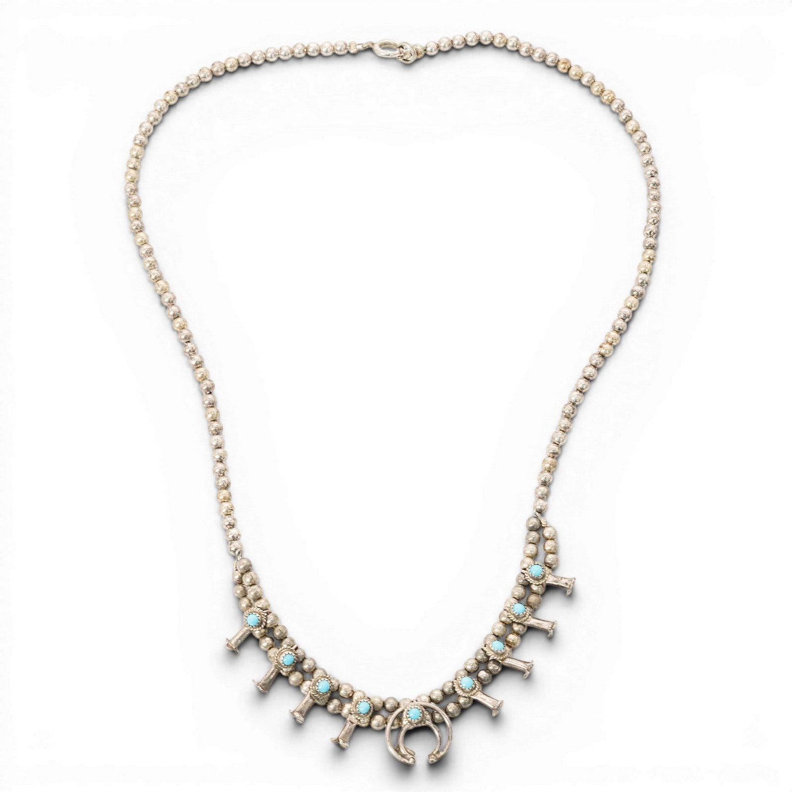 Navajo Sterling Silver & Turquoise Squash Blossom Necklace: Navajo Sterling Silver & Turquoise Squash Blossom Necklace 1980s-1990s, USA Navajo sterling silver necklace composed of round silver beads, fitted with hook clasp and a small squash blossom-style pend
