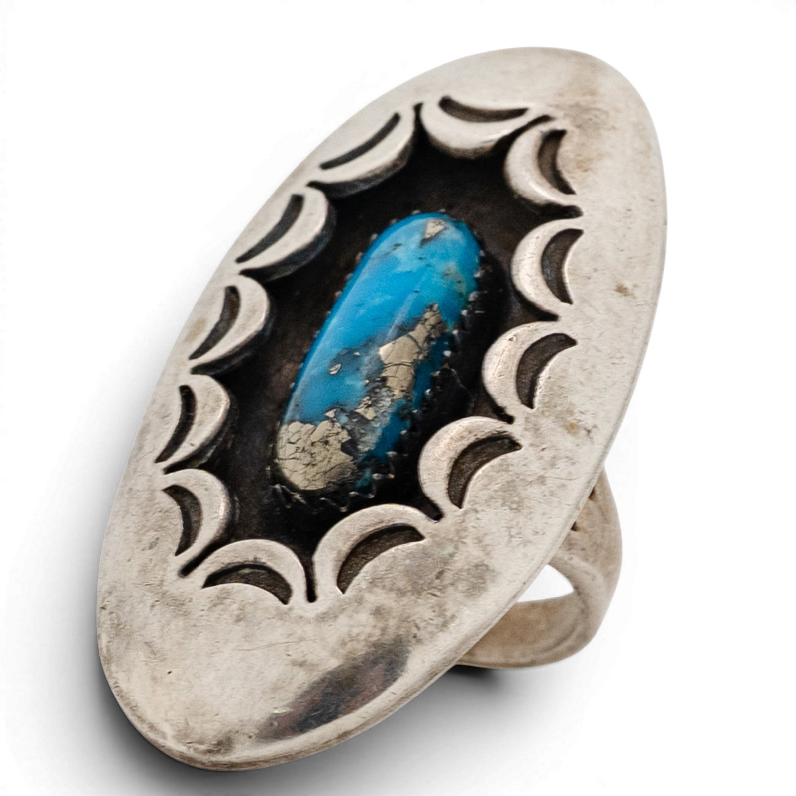 Vintage Navajo Sterling Silver & Turquoise Shadowbox Ring: Vintage Navajo Sterling Silver & Turquoise Shadowbox Ring 1970s-1980s, USA Elongated oval turquoise cabochon with natural matrix set in a serrated bezel, within a deep shadowbox frame. Surround featur