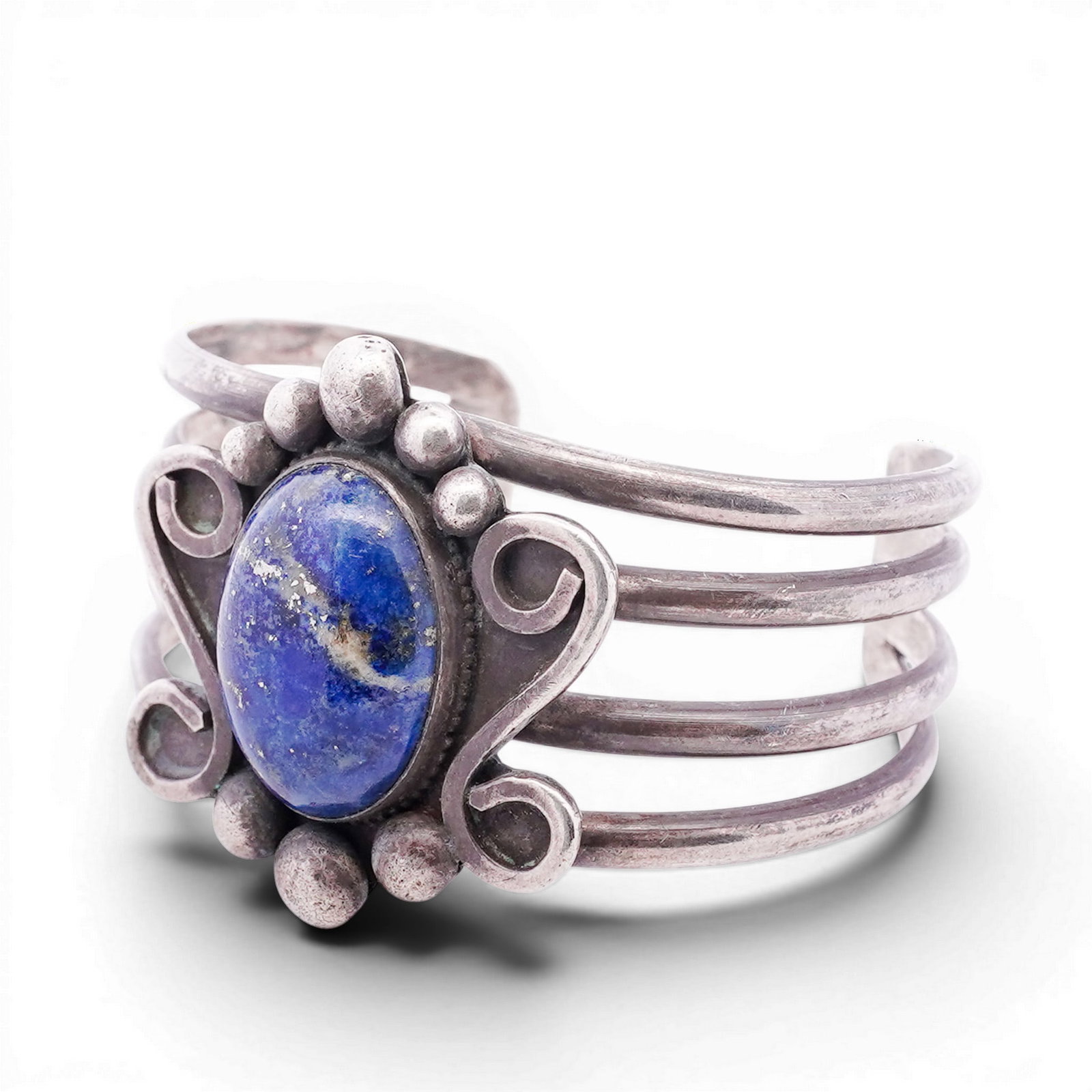 Vintage Navajo Sterling Silver & Lapis Lazuli Cuff Bracelet: Vintage Navajo Sterling Silver & Lapis Lazuli Cuff Bracelet 1970s-1980s, USA Hand-fabricated cuff bracelet centered with a large oval lapis lazuli cabochon set in a serrated bezel, surrounded by appli