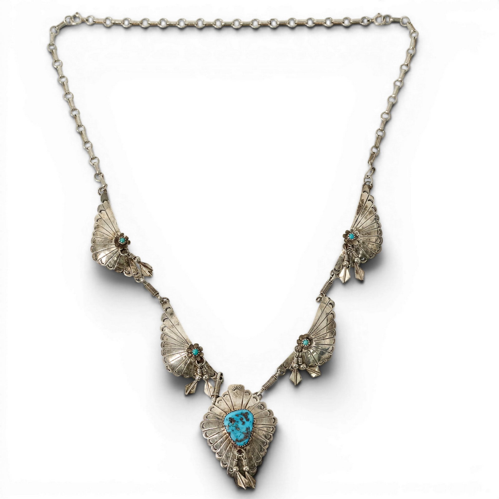 Vintage Navajo Sterling Silver & Turquoise Panel Necklace: Vintage Navajo Sterling Silver & Turquoise Panel Necklace 1970s-1980s, USA Navajo sterling silver squash blossom style necklace with repoussé fan-form panel links, applied arrow motifs, turquoise cab