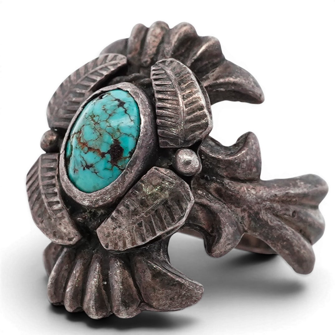 Vintage Navajo Sterling Silver & Turquoise Leaf Ring: Vintage Navajo Sterling Silver & Turquoise Leaf Ring 1970s-1980s, USA Silver ring featuring an oval turquoise cabochon displaying bright blue-green coloration with natural brown matrix. The stone is b