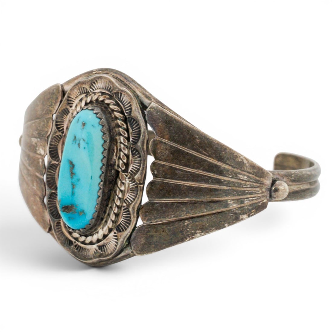 Vintage Navajo Sterling Silver & Turquoise Cuff Bracelet: Vintage Navajo Sterling Silver & Turquoise Cuff Bracelet 1970s-1980s, USA Sterling silver cuff bracelet set with an elongated oval turquoise cabochon in a rope-twist bezel, surrounded by a stamped sca