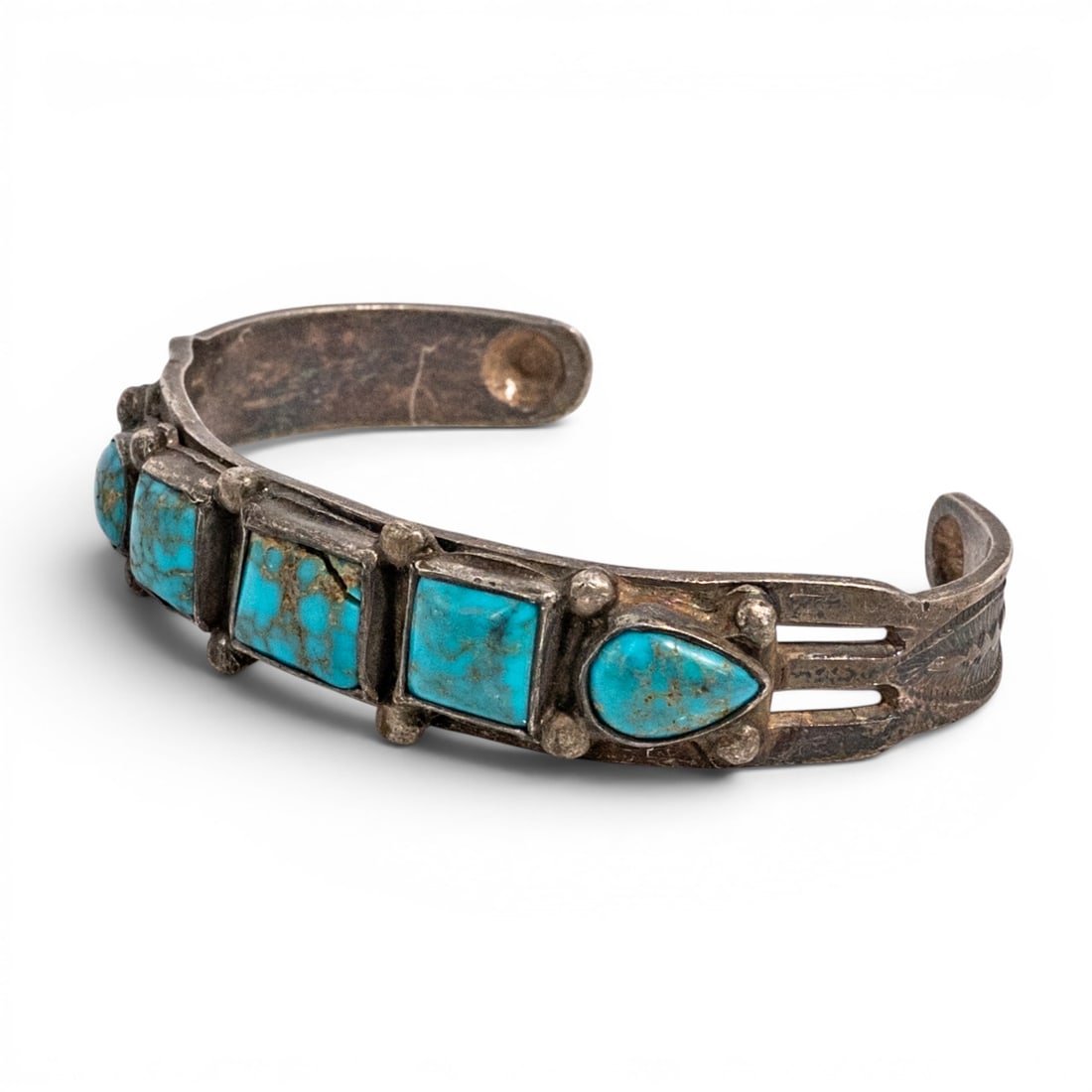Vintage Navajo Sterling Silver & Turquoise Row Cuff Bracelet: Vintage Navajo Sterling Silver & Turquoise Row Cuff Bracelet 1970s-1980s, USA Hand fabricated sterling silver cuff bracelet set with graduated turquoise cabochons including rectangular and pear forms 