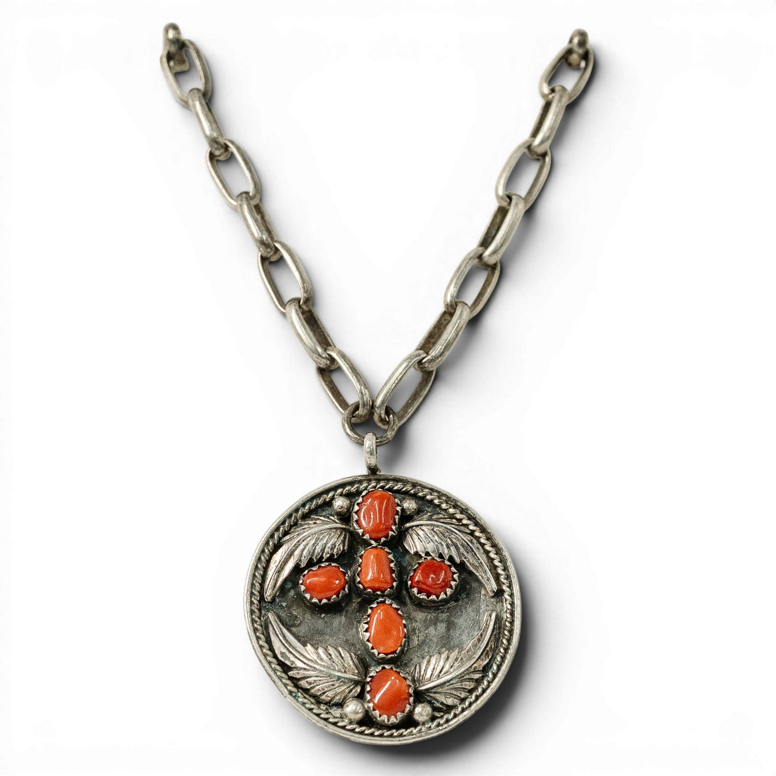 Vintage Navajo Sterling Silver & Coral Concho Necklace: Vintage Navajo Sterling Silver & Coral Concho Necklace 1970s-1980s, USA Vintage Hand fabricated sterling silver necklace featuring a circular concho pendant set with six coral cabochons in serrated be