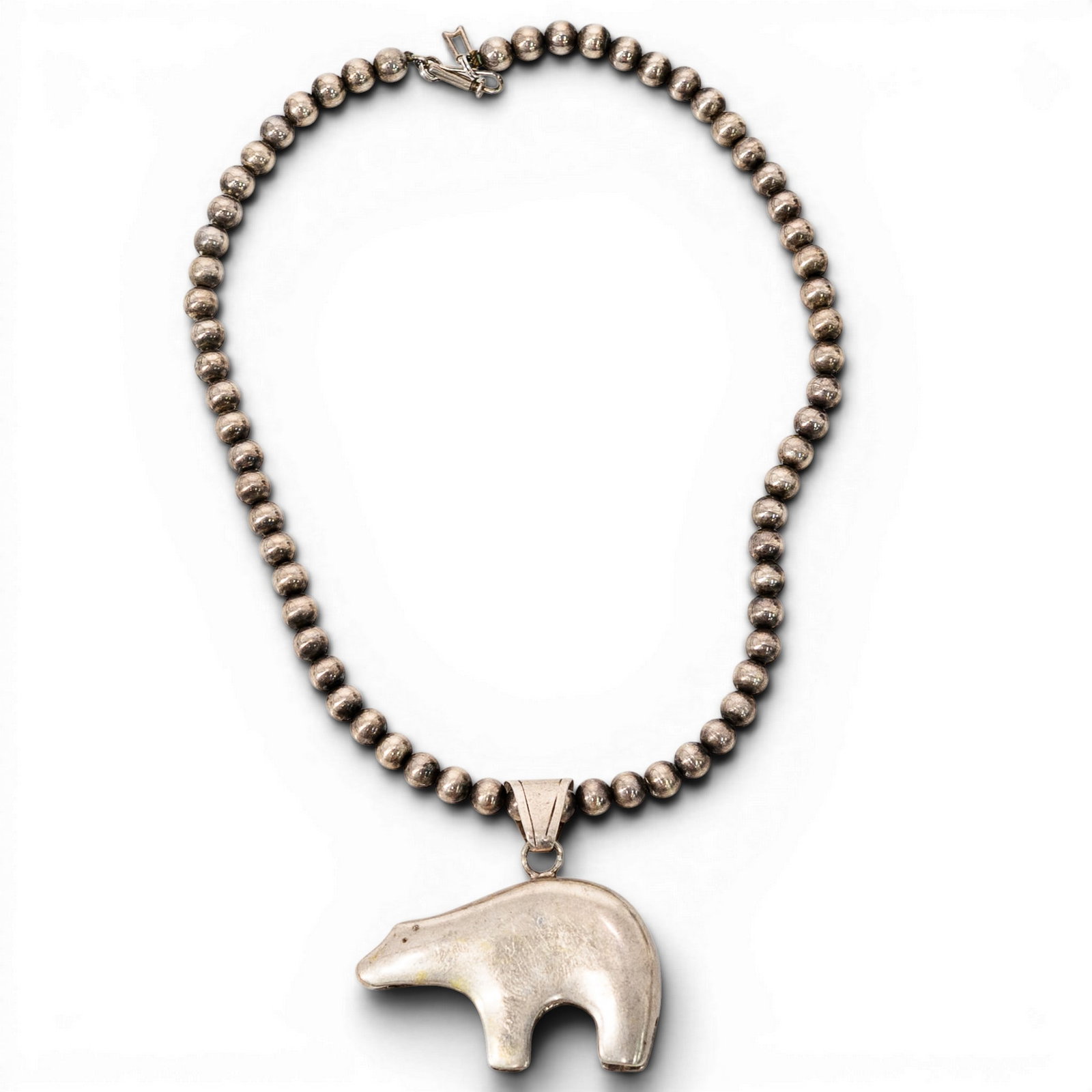 Navajo Sterling Silver Bear Pendant Necklace Signed: Navajo Sterling Silver Bear Pendant Necklace Signed 1980s-1990s, USA Navajo sterling silver necklace composed of round silver beads, fitted with hook clasp and a large stylized bear-form pendant drop.