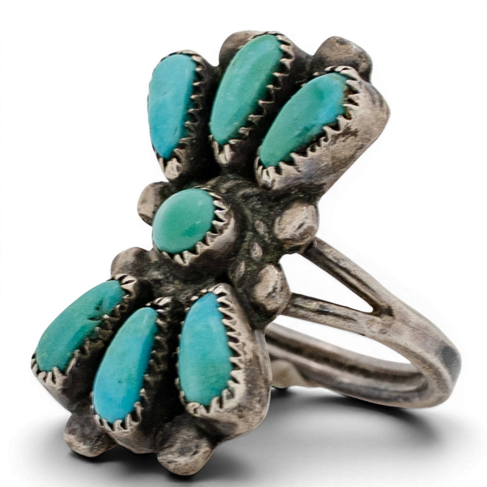 Vintage Bill & Lou Laweka Zuni Turquoise Cluster Ring: Vintage Bill & Lou Laweka Zuni Turquoise Cluster Ring 1970s-1980s, USA Cluster ring composed of seven teardrop turquoise cabochons surrounding a central round turquoise stone, each set in serrated bez