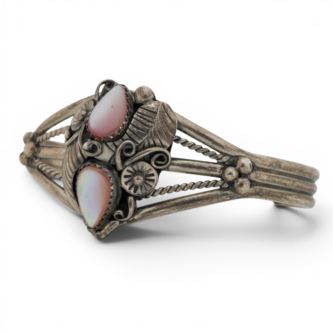 Vintage Navajo Sterling Silver & Pink Opal Cuff Bracelet: Vintage Navajo Sterling Silver & Pink Opal Cuff Bracelet 1970s-1980s, USA Sterling silver cuff bracelet featuring two pear-shaped pink opal cabochons set in serrated bezels. The stones are mounted wit