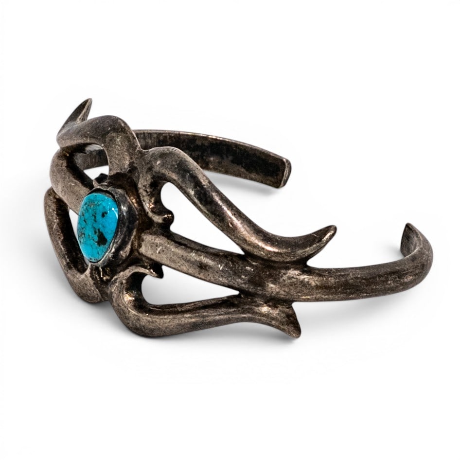 Southwestern Sterling Silver & Turquoise Openwork Cuff Bracelet Signed: Southwestern Sterling Silver & Turquoise Openwork Cuff Bracelet Signed Late 20th century, USA Southwestern sterling silver cuff bracelet with openwork split-band construction centered by a round turqu