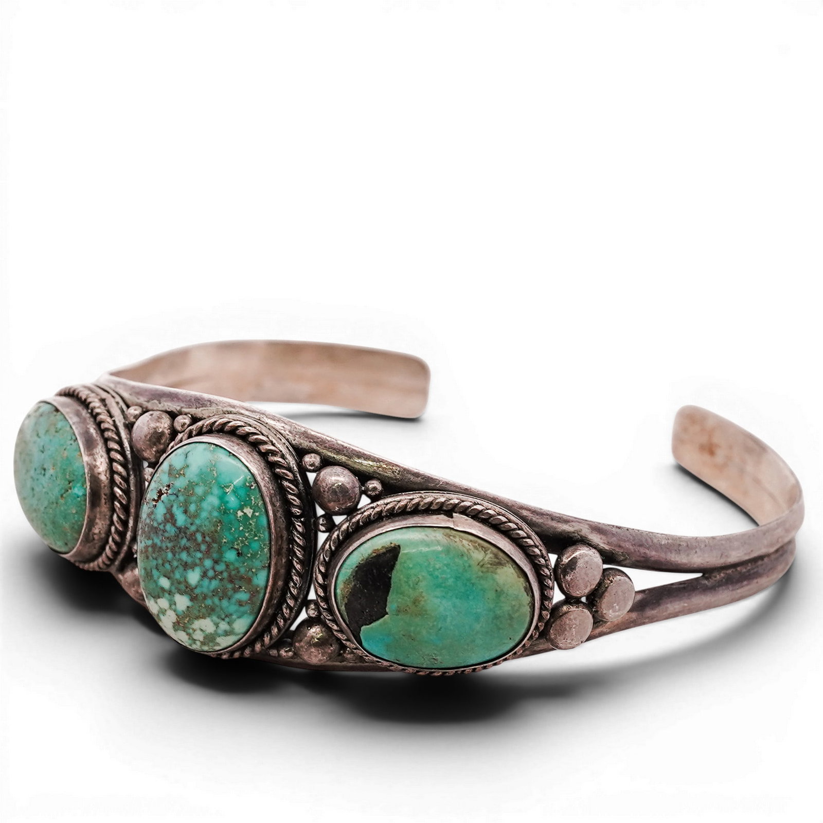 Vintage Navajo Sterling Silver & Turquoise Cuff Bracelet: Vintage Navajo Sterling Silver & Turquoise Cuff Bracelet 1970s-1980s, USA Vintage Navajo sterling silver cuff set with three oval turquoise cabochons, each in rope-twist bezels, with applied silver be